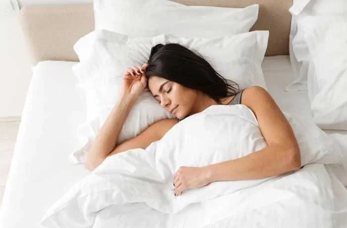 Yatağa sırtüstü yatmış bir kadın