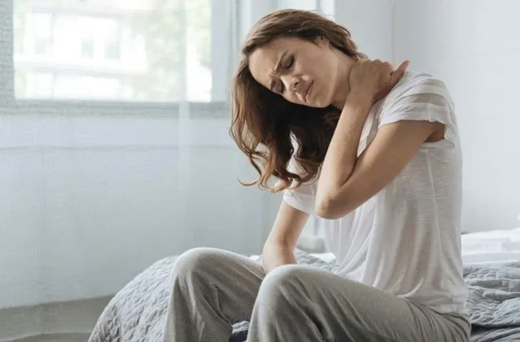 Boynunu tutan bir kadın