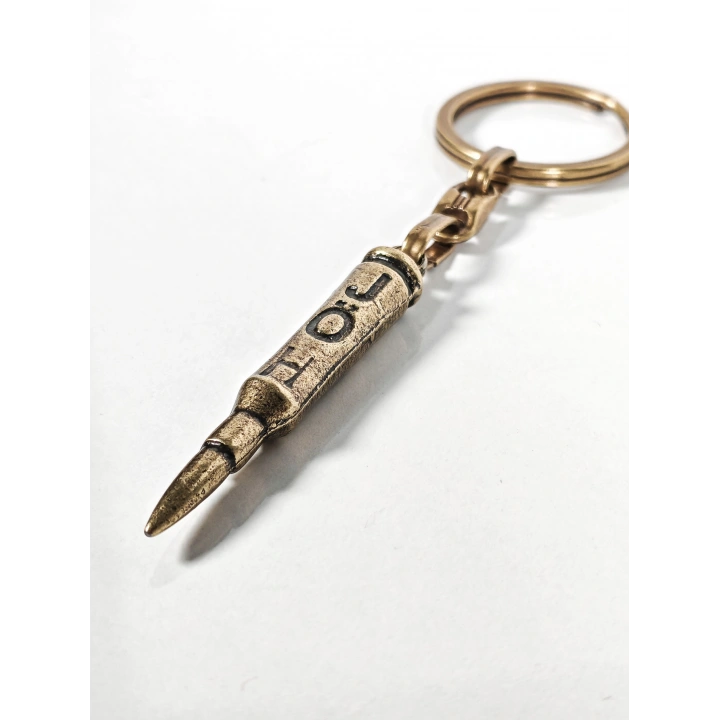 Antik Bronz Mermi Figürlü Metal Anahtarlık – Güç, Kararlılık ve Net Duruşun Sembolü