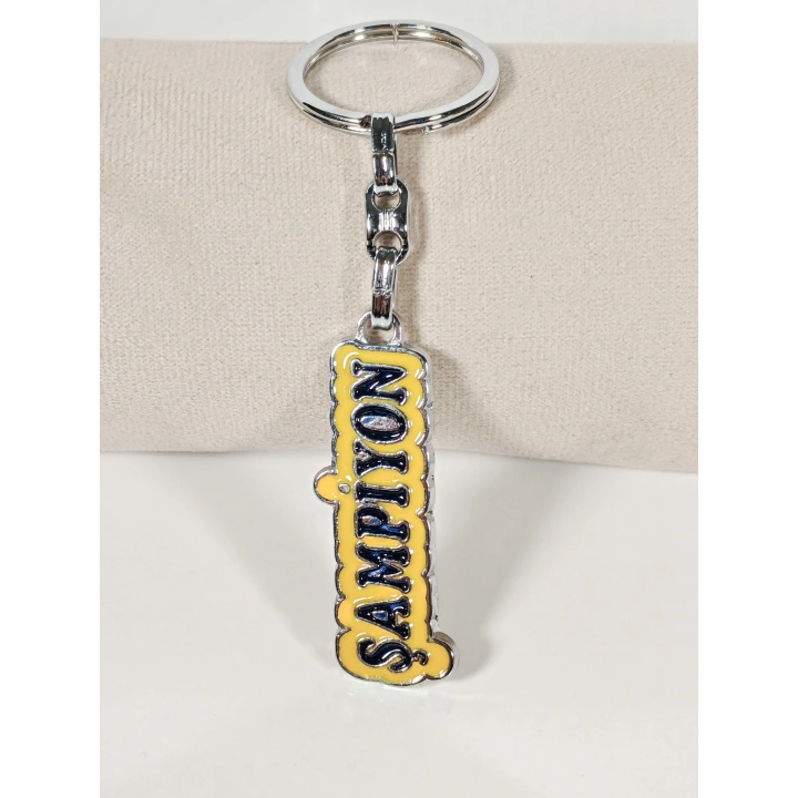 Sarı Üzerine Lacivert  “Şampiyon” Yazılı Metal Anahtarlık – Başarının ve Özgüvenin Simgesi