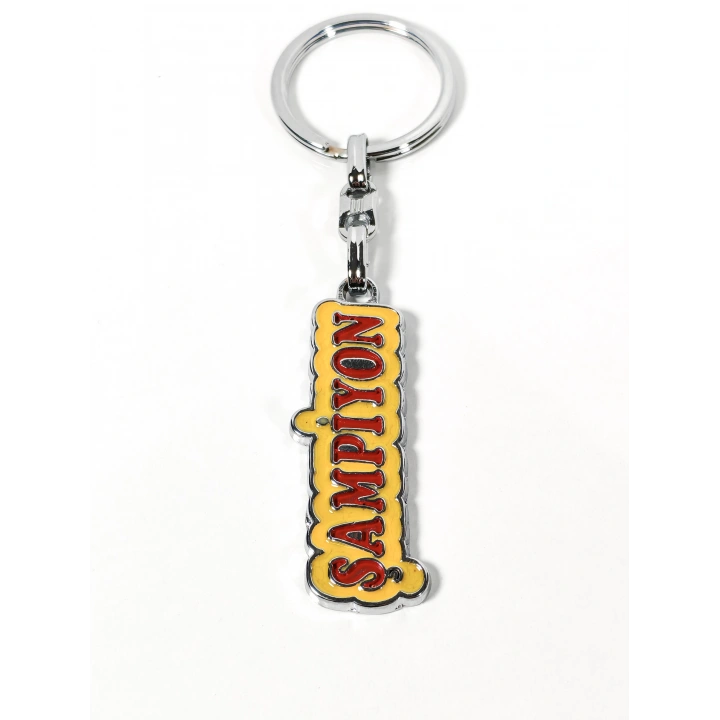 Şampiyon Yazılı Sarı Kırmızı Metal Anahtarlık – Enerjik Tasarım ve Güçlü Duruşun Eğlenceli İfadesi