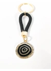 Siyah Örgü İpli Nazar Motifli Yuvarlak Metal Anahtarlık – Modern, Güçlü ve Şık Tasarım