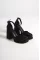Black Satin Woman İn Front Of The Platform Heel Shoes